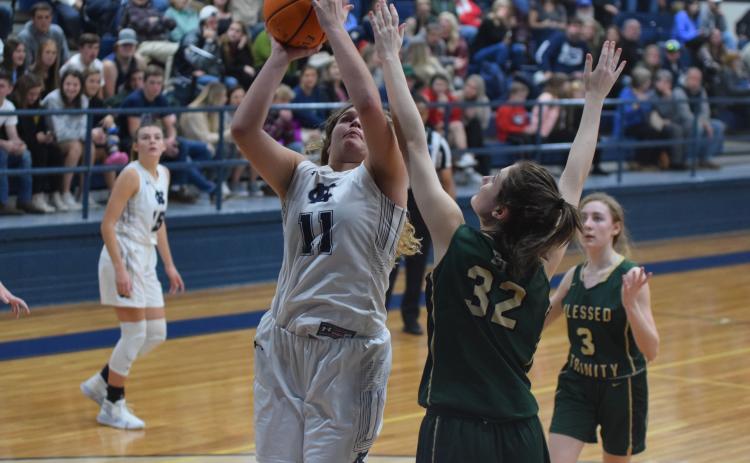 Maddie Futch scores over Blessed Trinity's Erin Hynekamp during the Lady Warriors' region win Tuesday night in Cleveland. (Photo/Mark Turner)