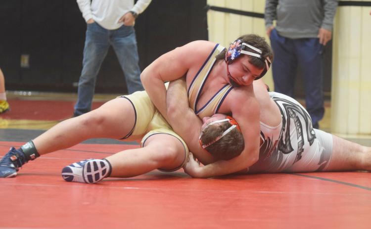White County's Devin Sullens pins Flowery Branch's Clayton Walczuk to win the Region 7-AAAA championship match in the 285-pound division. Sullens had a pair of pins during the region tournament last Saturday at Flowery Branch High School, and earned a spot in the Class AAAA sectionals this weekend in Perry. (Photo/Mark Turner)
