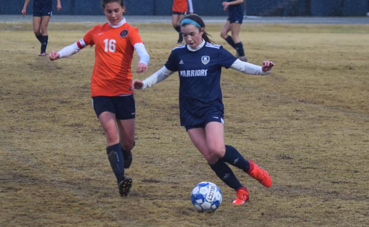 Sydnee Nix, right, beats Habersham Central's Taylor Acker to the ball during Tuesday's match in Cleveland. (Photo/Mark Turner)