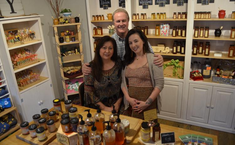 Honey on the Hill owners Anna and Dale Fisher pose with store employee Abigail Thomas in the company’s first retail location in Helen. (Photo/Wayne Hardy)