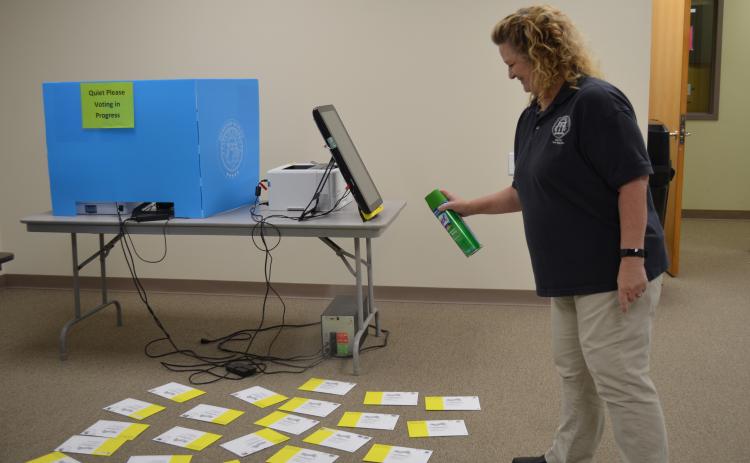 White County Chief Voter Registrar Lisa Manning said almost 1,500 absentee ballots had been completed and returned by voters as of May 11. She is shown sanitizing some of them as part of the office’s COVID-19 precautions. (Photo/Stephanie Hill)