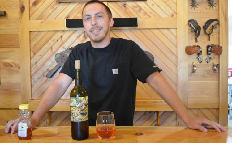 Lane Williams shows off the 2019 Tesnatee River rosé wine that took home the silver award in the 2020 Experience Rosé Competition. (Photo/Stephanie Hill)