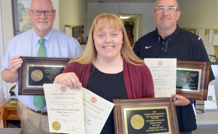 From left, White County News marketing specialist Tom Tucker, reporter Stephanie Hill and Sports Editor Mark Turner hold some of the newspaper’s recent awards from the Georgia Press Association Better Newspaper Contest.