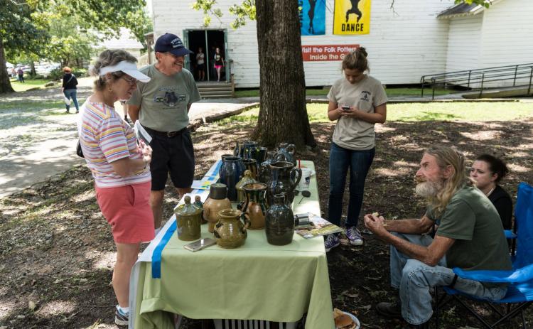 Visitors speak with a potter at a previous event on the Sautee Nacoochee Center campus. (Submitted photo)