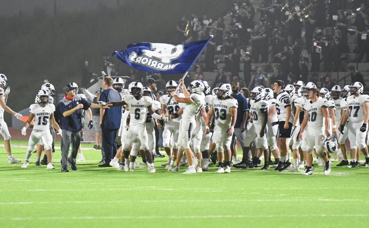 The WCHS players fly the Warrior flag moments after finishing off a 28-21 win over Habersham Central. (Photos/Tom Askew)