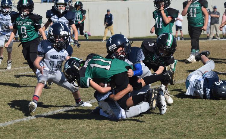 Ryder Rewis of the 8U team makes a tackle during the winning effort. (Photo/Mark Turner)