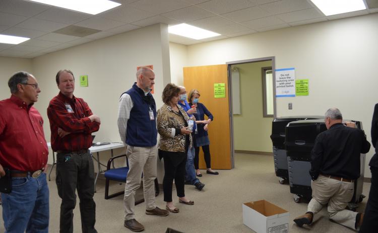 Election Superintendent Garrison Baker shows the newly formed White County Board of Elections how to retrieve the paper ballots from the machines at the voter registrar office. He also explained the process of what to do with the ballots after they are collected. (Photo/Stephanie Hill)