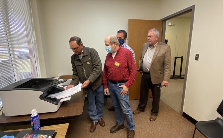 A demonstration of how ballots were scanned during the most recent recount was given Monday, Nov. 30. Shown from left are Board of Elections member Dwayne Turner, poll worker John Connell, County Chairman Travis Turner and County Elections Superintendent Garrison Baker. There were no changes to the White County results during the second recount completed last week. (Photo/Stephanie Hill)