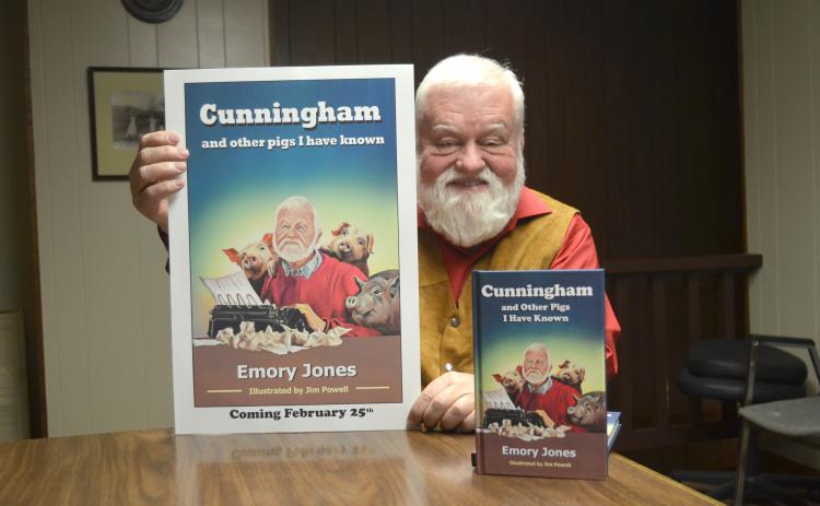 Emory Jones holds a poster featuring his book, Cunningham and Other Pigs I Have Known. (Photo/Wayne Hardy)