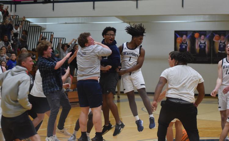 WCHS' Tavi Simmons, right, celebrates with Alex Garcia, left, and Zion McMullen moments after the Warriors knocked off Lakeview-Fort Oglethrope in the opening round of the Class AAA tournament Tuesday in Cleveland. (Photos/Mark Turner)