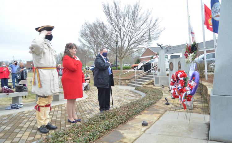 White County’s fallen military service members were honored with a wreath placed at a memorial in Freedom Park during the program. Shown from left are Ed Hendricks, color guard member for the Joseph Habersham Chapter of the Sons of the American Revolution, Cindy Grace, regent for the Tomochichi Chapter of the Daughters of the American Revolution, and Gary Hoyt, veterans committee chairman for the Georgia Society, Sons of the American Revolution. (Photo/Wayne Hardy)