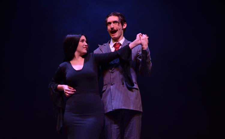 Ben Perrin, who plays Gomez Addams, and Ireland Ballington, who plays Morticia Addams, danced together during the opening number of dress rehearsals on Monday, April 19.