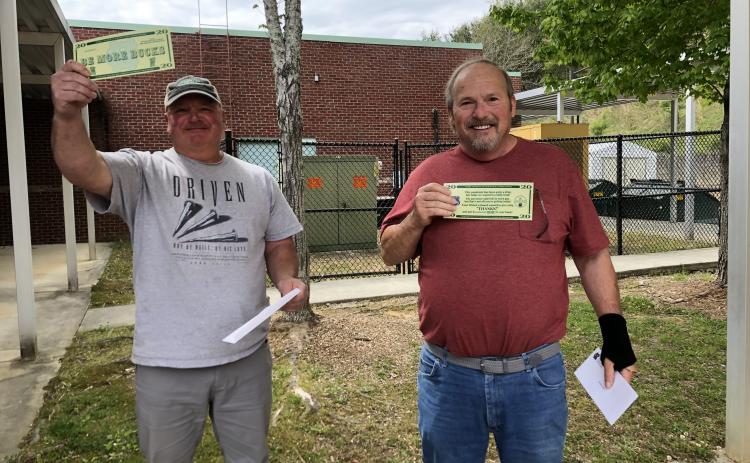 School bus drivers Avery Clark and Mike Ray react to surprise “Be More Bucks” presentations noting they would receive an additional $2,020 bonus on top of $1,000 previously promised by Gov. Brian Kemp. (Submitted photo)