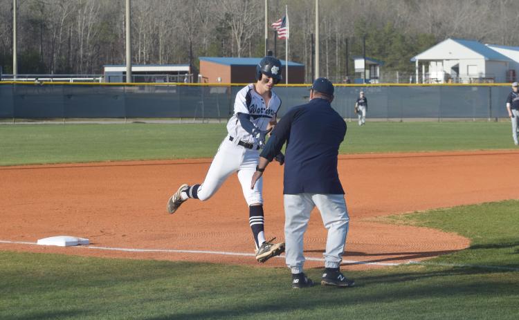 J. Ben Haynes is congratulated at third base by head coach Jim Waits after hitting a 2-run home run in the the first inning of the region win Tuesday over West Hall. (Photo/Mark Turner)
