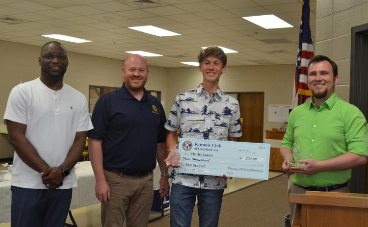 Dr. Octavius Mulligan and Kiwanis President Jason Hogan present plaques to STAR student Charles Causey and STAR teacher Kalin Kennedy. Causey was also presented with a $500 scholarship. Pictured from left, Mulligan, Hogan, Causey and Kennedy. (Photo/Stephanie Hill)