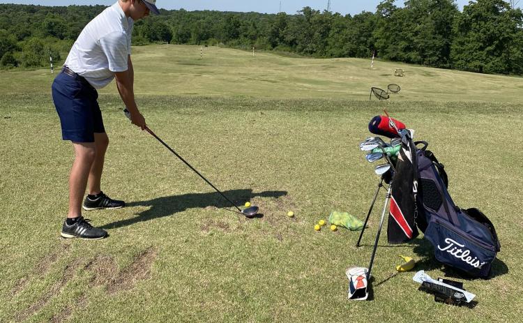 Jacob Adams gets in some work at the driving range  Monday morning before the start of the Class AAA state tournament in Hartwell. (Photo/WCHS Athletics)