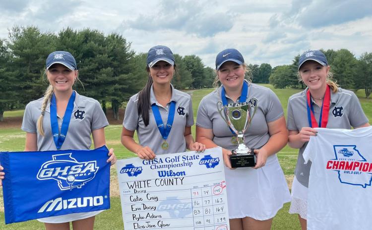 WCHS golfers, from left, Catie Craig, Eliza Jane Glover, Erin Dorsey, and Rylee Adams show off the Class AAA championship trophy Tuesday after winning the school's first ever spring sports team title. (Photo/WCHS Athletics)