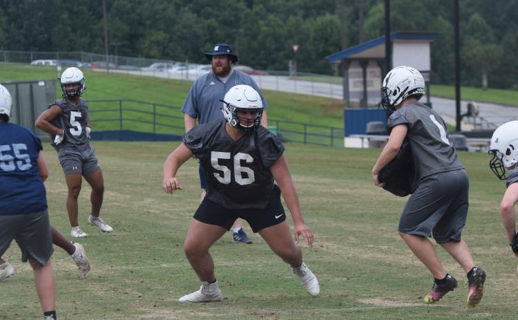Offensive tackle JD Trowell, an All-Region pick last season, works during a team drill Tuesday at the Warriors' second acclimation practice session. (Photo/Mark Turner)