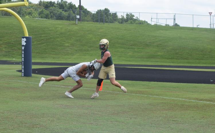 Kanaan Cleveland, left, shown hauling in a touchdown pass  during a 7-on-7 game earlier this summer, and the rest of the Warriors spent two day this week at an FCA Team Camp at Jacksonville State University in Alabama.  (Photo/Mark Turner)