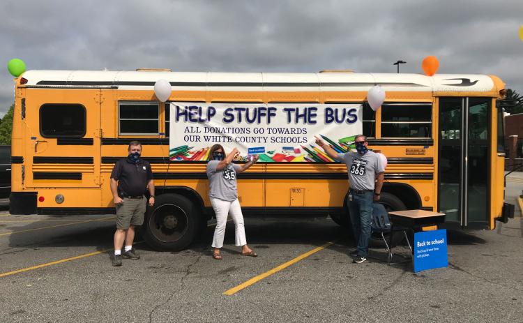 The annual Stuff the Bus event is set to take place July 23-Aug. 3. Pictured is Darren Sledge, transportation director, Dr. Laurie Burkett, superintendent, and Scott Justus, assistant superintendent, with the bus in 2020. (File photo)