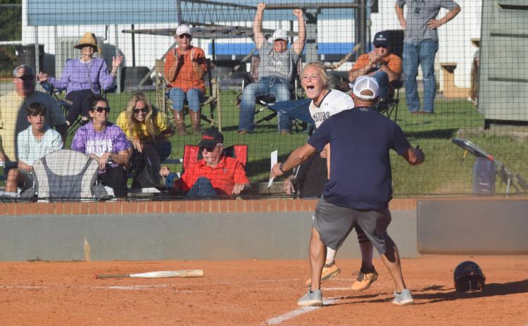 Katelyn Boman celebrates with WCHS head coach Drew Owens moments after scoring the winning run in a 4-3 victory over Cherokee Bluff. (Photo/Mark Turner)