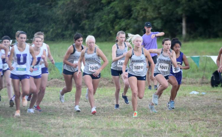 White County runners, from left, Lilly Gearing, Reese Vandegriff, Emily Davidson, Nealeigh Broadwell, and Emma Marrow, and Lumpkin County's Haley Souther break away the starting line last Thursday at the North Hall Invitational. (Photo/Mark Turner)