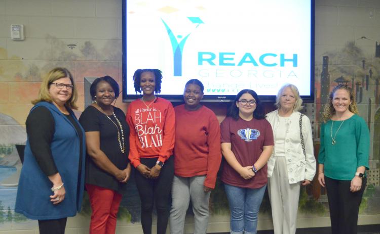 Shown from left at the Oct. 25 REACH Georgia scholarship signing are White County School Superintendent Dr. Laurie Burkett, White County Middle School Principal Nara Allen, Brittany Wilmont, Jazmeene Wilmont, Serenaty Brown, Ella McCusker and White County High School Principal Mary Anne Collier. (Photo/Wayne Hardy)