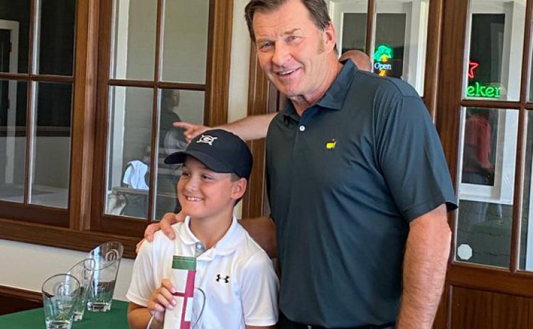 Hudson Justus, left, is shown with Master's champion Nick Faldo after winning the 10U division title last week at the Faldo Hurricane Series 2021 Grand Final. (Photo/Scott Justus)
