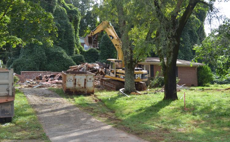 A former home at the corner of Quillian Street and South Main Street in Cleveland was demolished earlier this week at the site planned for construction of a Popeyes restaurant and T-Mobile store. (Photo/Stephanie Hill)