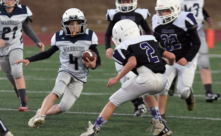 Lane Bray looks for some running room during the fifth grade game against Gilmer County. (Photo/Mark Turner)