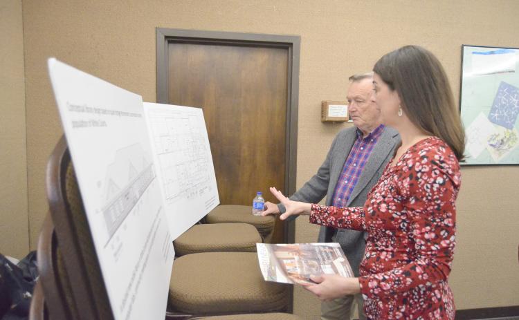 Northeast Georgia Regional Library System Director Delana Knight discusses a concept design for a new library with White County Commissioner Terry Goodger. (Photo/Wayne Hardy)