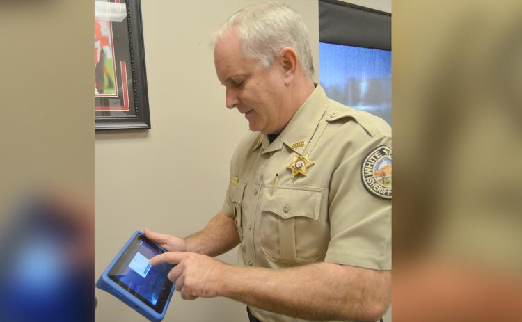 White County Sheriff Rick Kelley shows a smart tablet loaded with programs intended to address a variety of needs for inmates with the goal on reducing risk of recidivism.