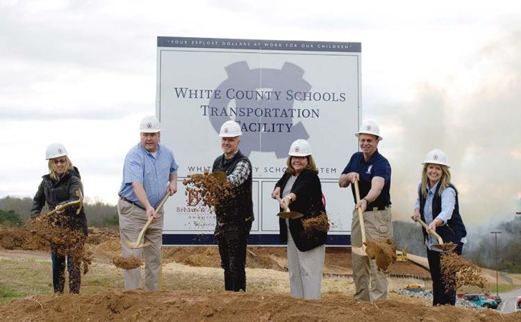 Board of Education members toss dirt in front of the site next to Tesnatee Gap Elementary School. Shown from left are Linda Erbele, John Solmon, John Estes, School Superintendent Dr. Laurie Burkett, Charlie Thomas, and Missy Jarrard. (Photo/Ashley Blair)