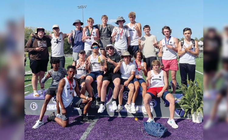 The White County Warriors celebrate after winning the Region 7-AAA track championship last Friday at Cherokee Bluff High School. The region title is the second straight for the boy's program. 