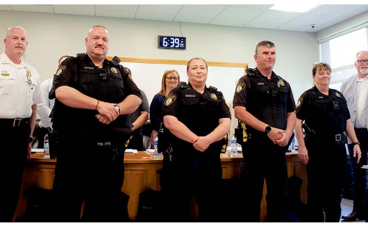From left, Cleveland Police Chief Jeff Shoemaker, CPD Officers Rayner, Riebold, Addis, and Sims sporting bullet proof vests and President of North Georgia Mountains Lodge #112 Micheal Palmer at the city council meeting held on May 9. (Ashley Blair/WCN)
