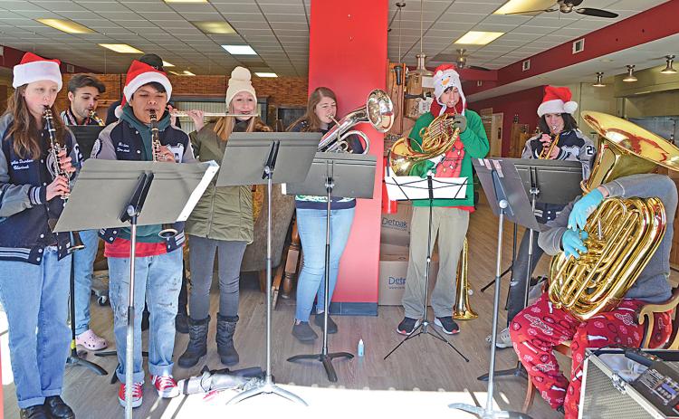 On Friday, Farmhouse Coffee hosted student and alumni musicians from White County High School who played Christmas songs. From left are Lydia Durden, Benjamin Catchings, Ribaldo Matias, Tyler Franklin (out of sight behind Ribaldo), Aynsley Franklin, Sarah Adams, Keegan Gauntt, Timothy Lingle and Marco Mastrogiovanni. The Winter Wonderland included artificial snow which quickly disappeared into the single-digit temperatures outside the store on the Cleveland Square. (Photo/Linda Erbele)