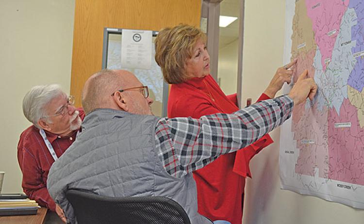 White County Board of Elections and Registration members Mike Mays, Todd Marks and Louise Nix take a closer look at the precinct map to find potential polling place locations. (Photo/Samantha Sinclair)