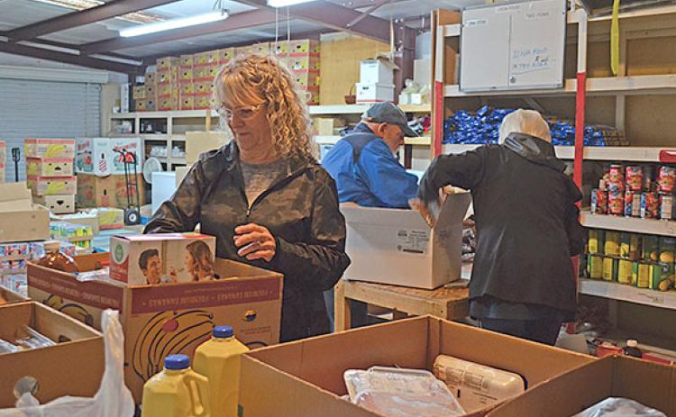 Volunteers sort food at the White County Food Pantry Tuesday morning. (Photo/Samantha Sinclair)
