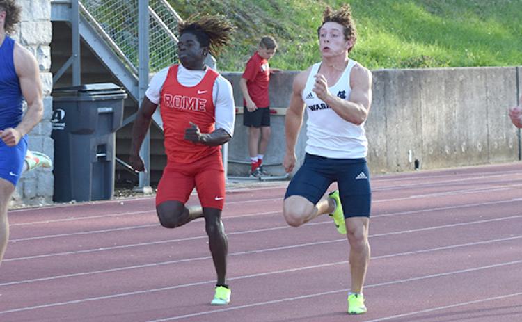 WCHS' Cam Wilson, right, and Rome's Antwion Carey speed down the track in the 100-meter race. Wilson finished third with a school-record time of 10.92. (Photo/Mark Turner)