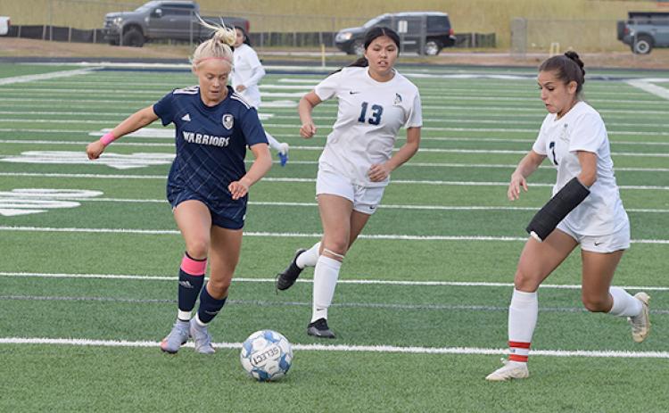 Nealeigh Broadwell, left, and the Lady Warriors need a win over Lumpkin County today to secure the No. 2 seed heading into the Class AAA state playoffs. With a win, the Lady Warriors would open the state tourament with a first round game at Warrior Stadium in April. (Photo/Mark Turner)