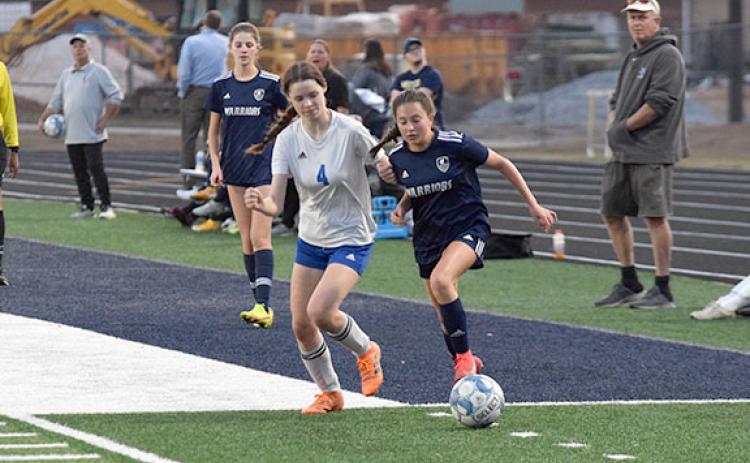 Isabella Moschiano, right, pushes the ball past a Banks County defender during the non-region win Monday night in Cleveland. (Photo/Mark Turner)