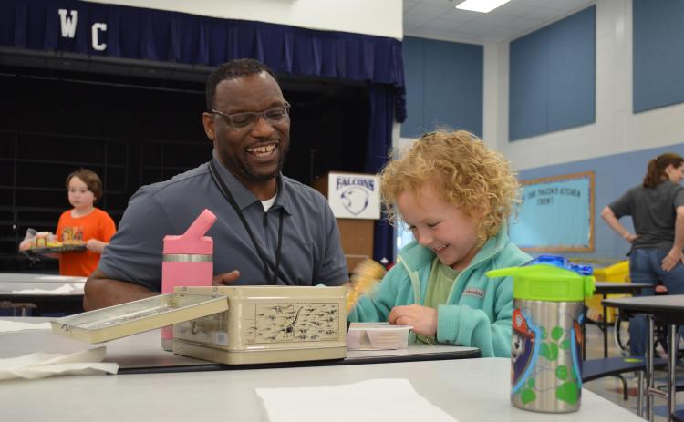 Tesnatee Gap Principal Octavius Mulligan shares a laugh with kindergartner Raleigh Brode in the cafeteria. (Photos/Samantha Sinclair)