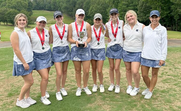 The Lady Warriors show off the GHSA hardware after finishing second at the Class AAA state tournament Tuesday in Columbus. Shown are, from left, Emma Rogers, Cameron Kimsey, BilliKayl Allison, Aubrey Free, Maddie Kate Hall, Layne Graham, Lauren Nelson and head coach Esta Johnson. (Photo/WCHS Athletics)