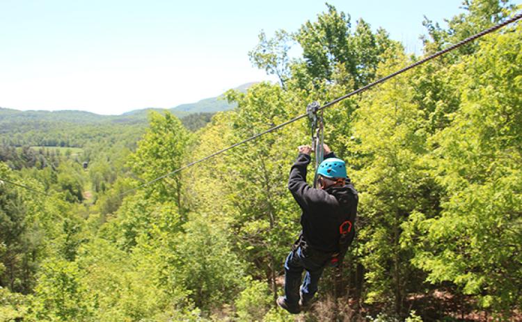 Leon White goes down “The Intimidator,” a half mile long zip line at Nacoochee Adventures with views of Mt. Yonah. (Photo/Jessica Wood)