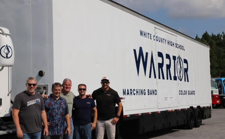 Warrior Band Director Michael Pickett and Band Booster President Donnie Filaski accept the truck and graphic wrap donation from Turbo’s Steve Syfan, Nicky Smith and Mike Trump. (Photo/submitted)