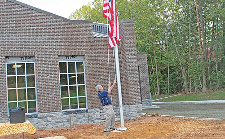 Commissioner Terry Goodger raises the American flag in remembrance of the 9/11 attacks. (Photo/Noah Johnson)
