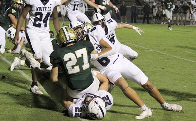 White County's Jason Rewis, No. 22, and Braxton Anderson bring down Wesleyan's Maddox Gartland durng the region game. Rewis had a team-high 11 total tackles and returned an interception for touchdown in the fourth quarter. (Photo/Mark Turner)