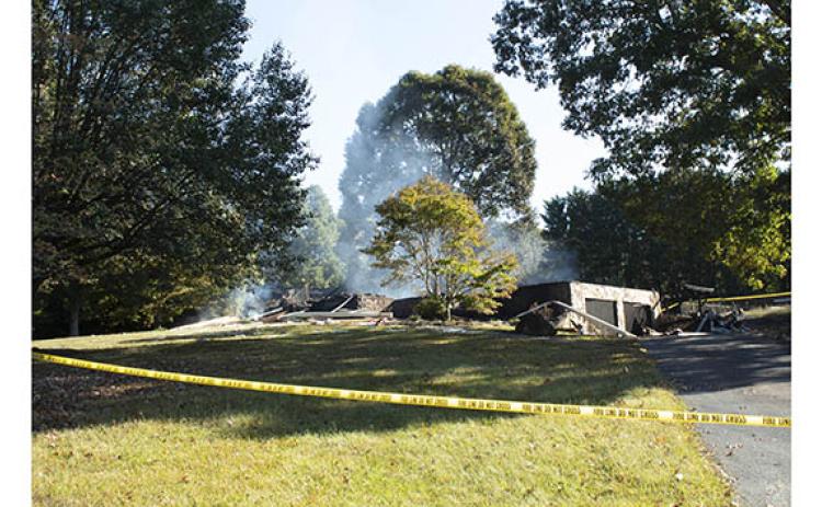 Smoke continues to rise Monday morning from the remains of the home involved in an explosion and fire. (Photo/Noah Johnson)