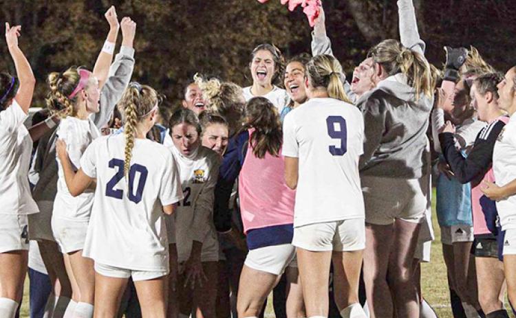 The members of the Truett McConnell women's soccer team celebrate moments after posting a 1-0 win over Tennessee Wesleyan in the AAC championship game in Cleveland. (Photo/Mark Turner)