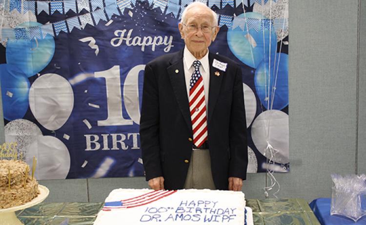 Dr. Amos Wipf poses with the cakes prepared for his birthday celebration. (Photo/Eric Tiongson)